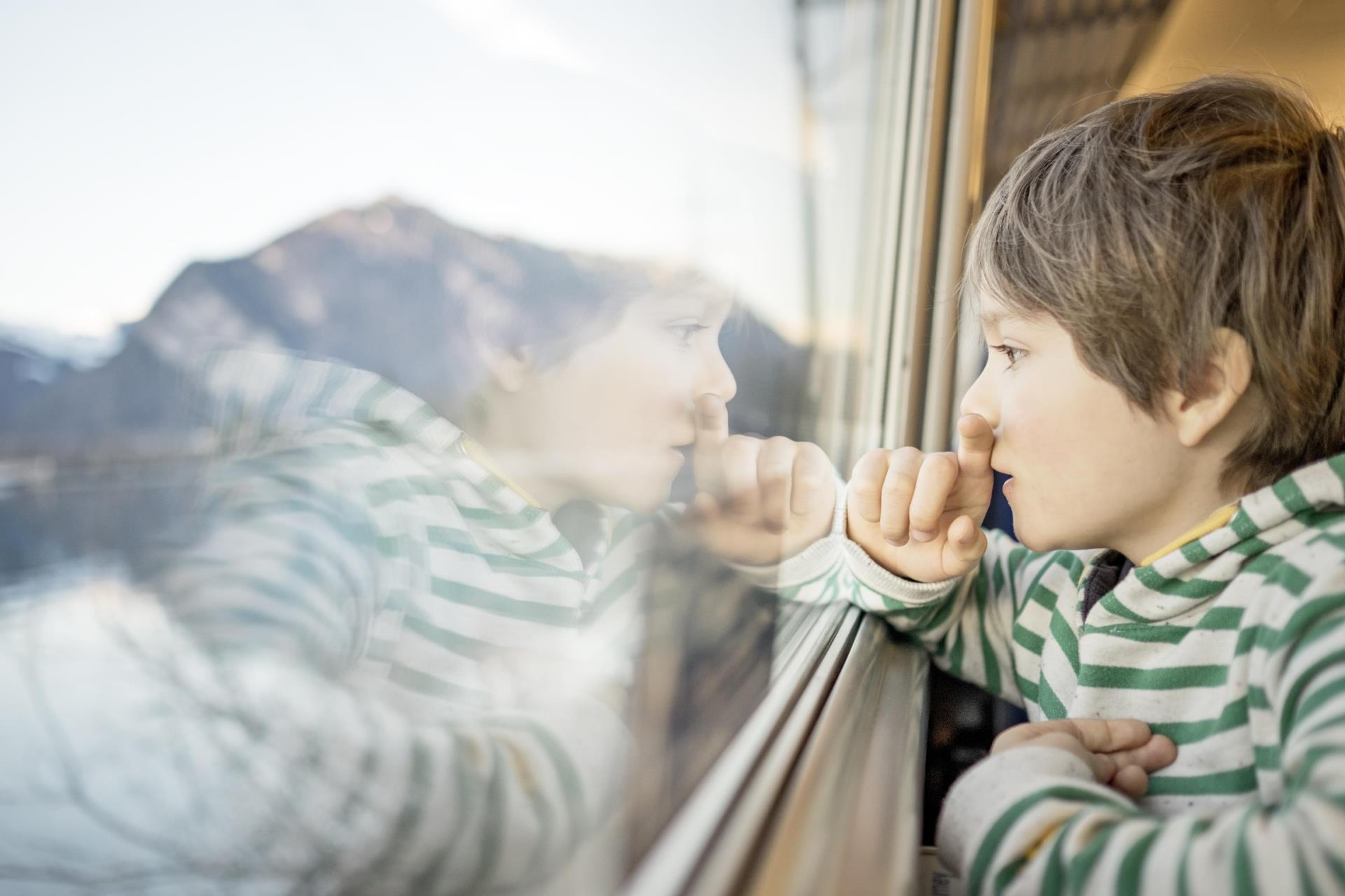 Kind schaut aus Zugfenster